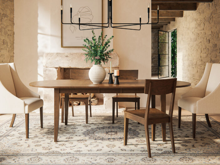 A large modern dining room area with a wooden table with 3 matching chairs and 2 fancy chairs
