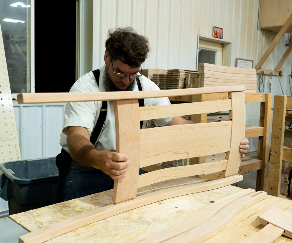 Hand-built chair back—precision work with minimal electricity for eco-friendly Amish craftsmanship.
